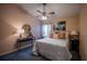 Comfortable main bedroom features neutral decor, a ceiling fan, and a decorative mirror at 1074 Canary S Cir, Lakeland, FL 33809