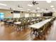 Community meeting hall filled with tables and chairs and several ceiling fans at 1074 Canary S Cir, Lakeland, FL 33809