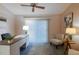 A well-lit office featuring neutral tones, a ceiling fan, and a modern desk with views of the exterior at 1074 Canary S Cir, Lakeland, FL 33809