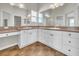 Well-lit bathroom featuring dual sinks, a vanity area, and plenty of storage at 879 Astor Way, The Villages, FL 32162