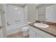 Bathroom featuring a tub, toilet and vanity with built in sink and fixtures at 879 Astor Way, The Villages, FL 32162