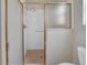 Bathroom featuring a shower with a gold framed glass door and white tiling at 879 Astor Way, The Villages, FL 32162