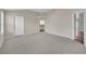 Bright bedroom featuring neutral walls, plush carpeting, and ample open space at 879 Astor Way, The Villages, FL 32162