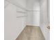Walk-in closet featuring carpeted flooring and metal shelving units at 879 Astor Way, The Villages, FL 32162