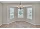Bright dining area with a chandelier and views from the large bay windows at 879 Astor Way, The Villages, FL 32162