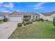 Beautiful single Gathering home with lush lawn and inviting front entrance at 879 Astor Way, The Villages, FL 32162