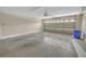 Spacious garage with a large garage door and ample room for parking and storage at 879 Astor Way, The Villages, FL 32162