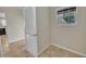 Inviting hallway with neutral paint, tile floor, and a bright window at 879 Astor Way, The Villages, FL 32162