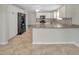 Open kitchen design with stainless appliances and a spacious breakfast bar at 879 Astor Way, The Villages, FL 32162