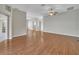 Expansive open-concept living space with laminate flooring and access to other rooms at 879 Astor Way, The Villages, FL 32162