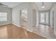 Open living space with hardwood flooring leading to a foyer and a view of the kitchen at 879 Astor Way, The Villages, FL 32162
