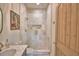 Elegant bathroom featuring a glass shower with pebble floor and a white marble countertop sink at 359 Terminal Ave, Polk City, FL 33868