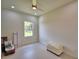 Bright bedroom with a window offering views of the outdoors, neutral walls and a ceiling fan at 359 Terminal Ave, Polk City, FL 33868