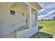 Inviting exterior view of a home featuring a bright entrance and a well-maintained, lush green lawn at 359 Terminal Ave, Polk City, FL 33868