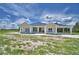 Bright, airy home featuring a covered front porch, modern design, and ample space for outdoor enjoyment at 359 Terminal Ave, Polk City, FL 33868