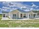 Stunning home showcasing a charming porch with modern railing, inviting entryway, and ample outdoor space at 359 Terminal Ave, Polk City, FL 33868