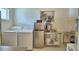 Bright laundry room with stainless steel appliances, washer, dryer, and ample counter space at 359 Terminal Ave, Polk City, FL 33868