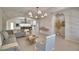 Bright living room featuring stylish furniture, tiled floors, and an open layout leading to the kitchen at 359 Terminal Ave, Polk City, FL 33868
