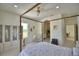 Spacious main bedroom with a four-poster bed, ensuite bathroom, and plenty of natural light at 359 Terminal Ave, Polk City, FL 33868