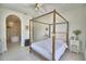 Inviting main bedroom with four-poster bed, ensuite bathroom, and neutral color palette at 359 Terminal Ave, Polk City, FL 33868