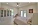Bright bedroom with a ceiling fan, closet, and access to an outdoor balcony at 359 Terminal Ave, Polk City, FL 33868