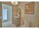 Elegant powder room features a stylish vanity, decorative mirror and a floral wall art at 359 Terminal Ave, Polk City, FL 33868