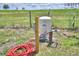 Outdoor well system and electrical panel set amidst a grassy field under a sunny sky at 359 Terminal Ave, Polk City, FL 33868