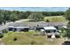 An aerial view highlights the property's layout, private patios, landscaping, and proximity to green space at 4709 Club Cir, Lakeshore, FL 33854