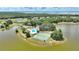 Aerial view of the community tennis courts and swimming pool facility situated by a lake at 4709 Club Cir, Lakeshore, FL 33854
