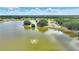Picturesque lake view featuring a fountain, tennis courts, and docks at 4709 Club Cir, Lakeshore, FL 33854