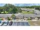 This aerial view highlights the home's attractive setting near parking spots and lush greenery at 4709 Club Cir, Lakeshore, FL 33854