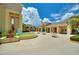 The community's sunny courtyard features a fountain and tables with colorful umbrellas for relaxing outdoors at 4709 Club Cir, Lakeshore, FL 33854