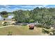 Aerial view of red gazebo nestled among the trees by the lake at 4709 Club Cir, Lakeshore, FL 33854