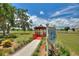 Charming community gazebo overlooking the lake with lush landscaping and walkway at 4709 Club Cir, Lakeshore, FL 33854