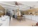 Bright and spacious community laundry room with multiple washers, dryers, folding tables and ceiling fans at 4709 Club Cir, Lakeshore, FL 33854