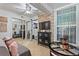 Bright living room with tile floors, stone accent wall, and built-in storage at 4709 Club Cir, Lakeshore, FL 33854
