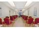 A community meeting room featuring rows of red chairs facing a podium, under fluorescent lighting at 4709 Club Cir, Lakeshore, FL 33854