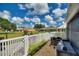 Paver patio with a white fence showcases outdoor living space, with a view to the open lawn at 4709 Club Cir, Lakeshore, FL 33854