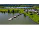 An aerial view displays the community lake, fishing pier, playground, and gazebo that provide outdoor activities at 5660 Elsinore Way, Lakeland, FL 33805