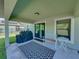 Outdoor covered patio with a barbecue grill, table and chairs, and a rug for outdoor comfort at 5660 Elsinore Way, Lakeland, FL 33805