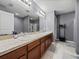 Primary bathroom showcasing a double sink vanity with granite countertops and a large mirror at 5660 Elsinore Way, Lakeland, FL 33805