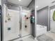 This bathroom has a large glass enclosed shower, soaking tub, and neutral paint at 5660 Elsinore Way, Lakeland, FL 33805