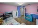Cozy bedroom featuring playful pink and blue walls with a comfortable chair and ample space at 5660 Elsinore Way, Lakeland, FL 33805