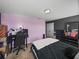 Bedroom with carpeted floors, purple accent wall, and black furniture at 5660 Elsinore Way, Lakeland, FL 33805