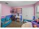 Bright bedroom with pastel walls, a daybed, white desk, and an abundance of natural light from a large window at 5660 Elsinore Way, Lakeland, FL 33805
