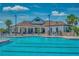 Enjoy the community pool featuring a clubhouse, blue skies and lounge chairs on a sunny day at 5660 Elsinore Way, Lakeland, FL 33805