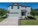Charming two-story home with a well-manicured lawn, inviting entrance, and attached garage at 5660 Elsinore Way, Lakeland, FL 33805