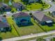 Aerial view of a well-maintained home with a large, fenced backyard and lush green lawn at 5660 Elsinore Way, Lakeland, FL 33805