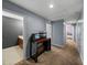 Upstairs hallway showcases neutral carpet and gray paint, adjacent to a bathroom and bedroom at 5660 Elsinore Way, Lakeland, FL 33805