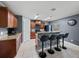 Kitchen with breakfast bar seating, dark cabinetry, and stainless steel appliances at 5660 Elsinore Way, Lakeland, FL 33805